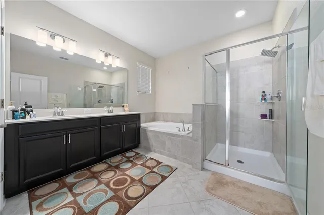 a bathroom with a double vanity sink mirror and shower