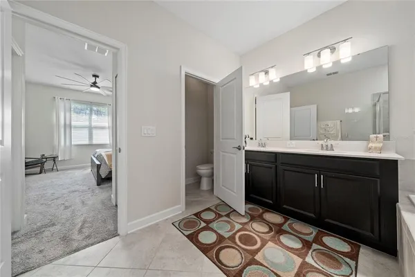 a spacious bathroom with a sink a mirror and a shower