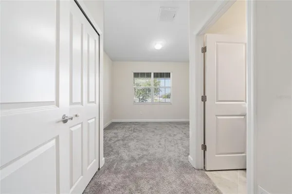 an entryway to room with windows