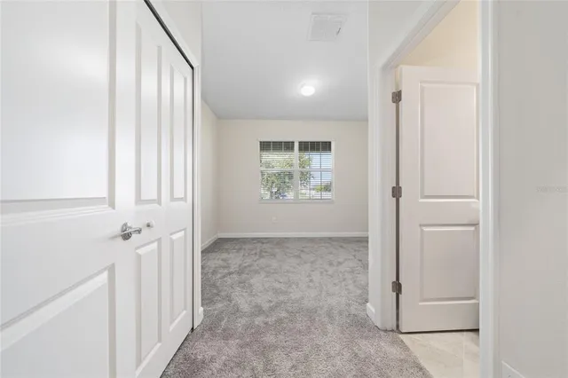 an entryway to room with windows