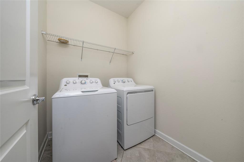 1701 Snapper Street St. Cloud, FL 34771 - Photo 21 of 29 a utility room with dryer and washer