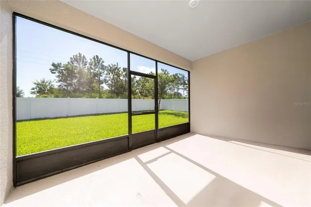 a view of porch with a floor to ceiling window next to a yard