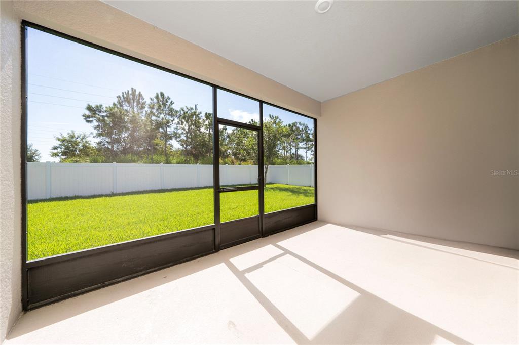 1701 Snapper Street St. Cloud, FL 34771 - Photo 22 of 29 a view of porch with a floor to ceiling window next to a yard