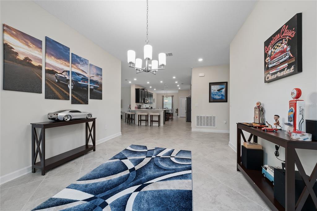1701 Snapper Street St. Cloud, FL 34771 - Photo 6 of 29 a living room with furniture a flat screen tv and kitchen view