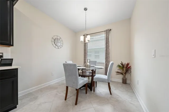 a dining room with furniture and window