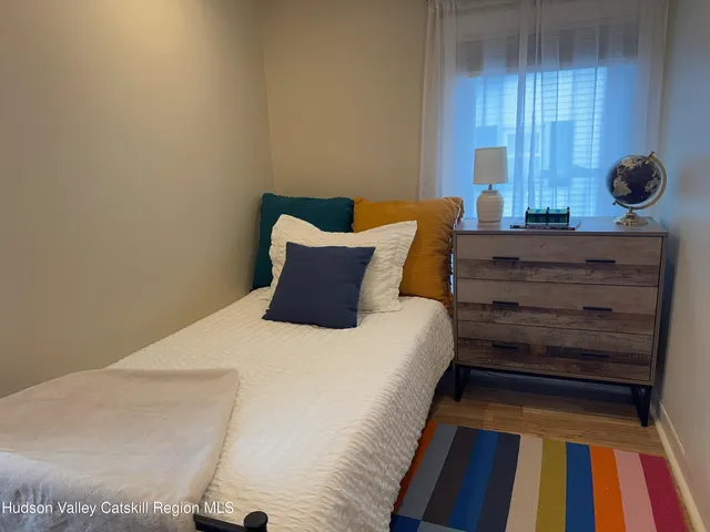 a bed sitting in a bedroom next to a window