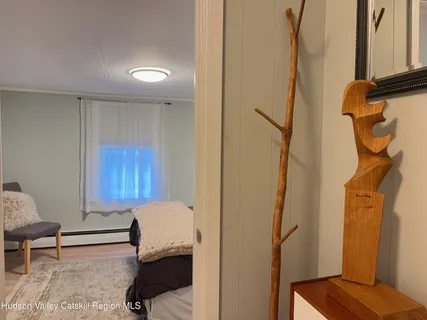 a bedroom with a bed and a lamp on dresser