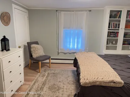 a living room with furniture and painting on the wall