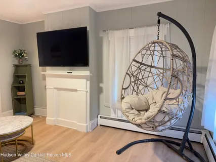 a living room with furniture a table and a chandelier