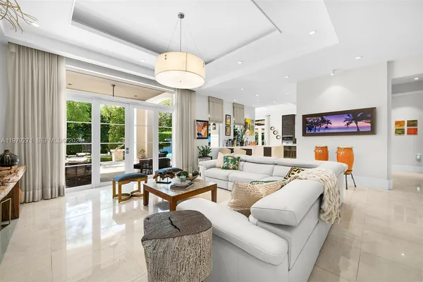 a living room with furniture kitchen and a chandelier