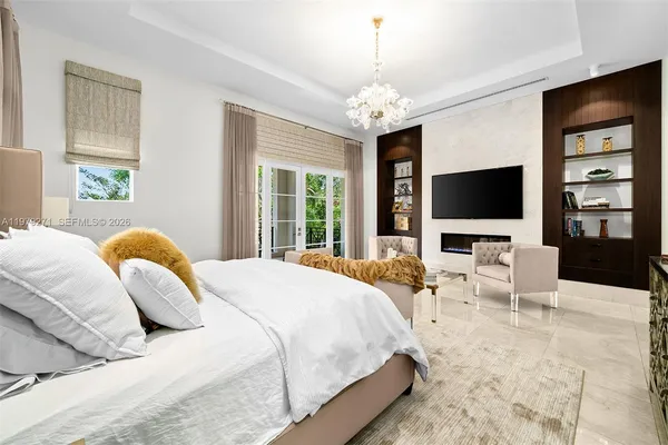 a bedroom with a bed television and a flat screen tv