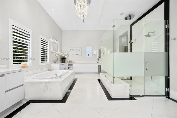 a bathroom with a tub sink and mirror