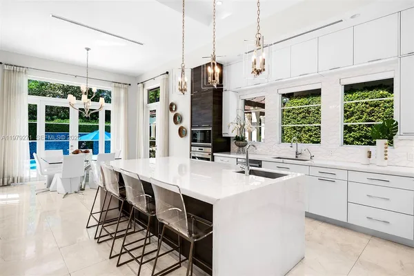 a kitchen with a sink stove and cabinets