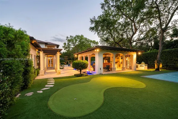a front view of a house with sitting area and garden