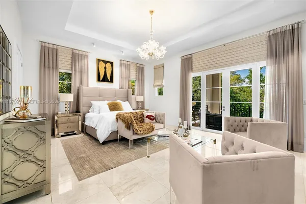a bedroom with bed couch and window