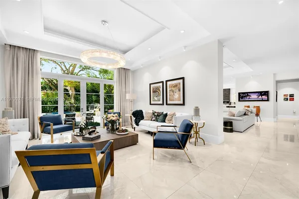 a living room with furniture and large windows