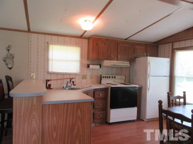 9565 George Ruff Road Bullock, NC 27507 - Photo 5 of 15 a kitchen with stainless steel appliances a stove a sink a refrigerator and a refrigerator