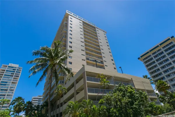 a front view of multi story residential apartment building with a yard