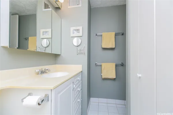 a bathroom with a sink a mirror and a window