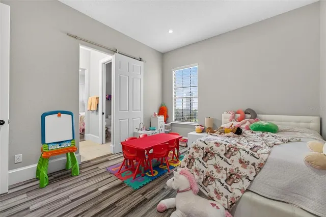 a living room with furniture a flat screen tv and a large window