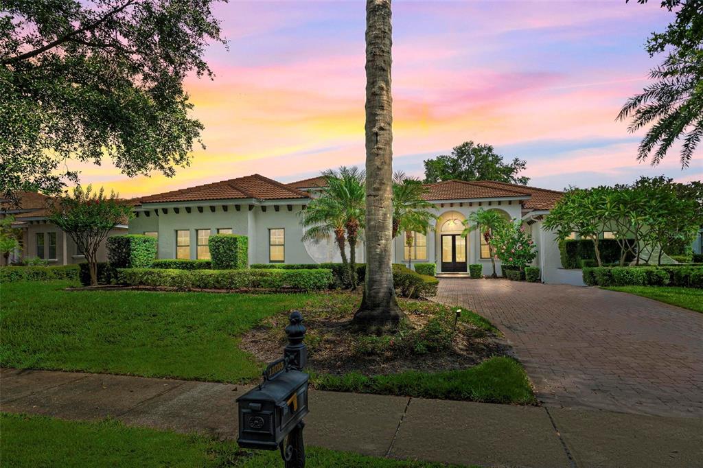 11015 Hawkshead Court Windermere, FL 34786 - Photo 2 of 90 a front view of a house with a yard and potted plants