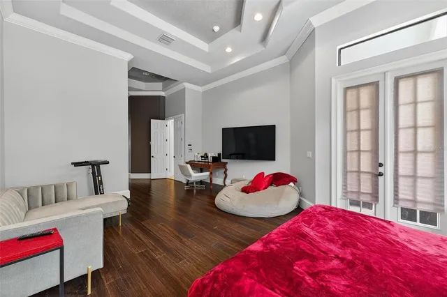 a bedroom with a bed and a chandelier