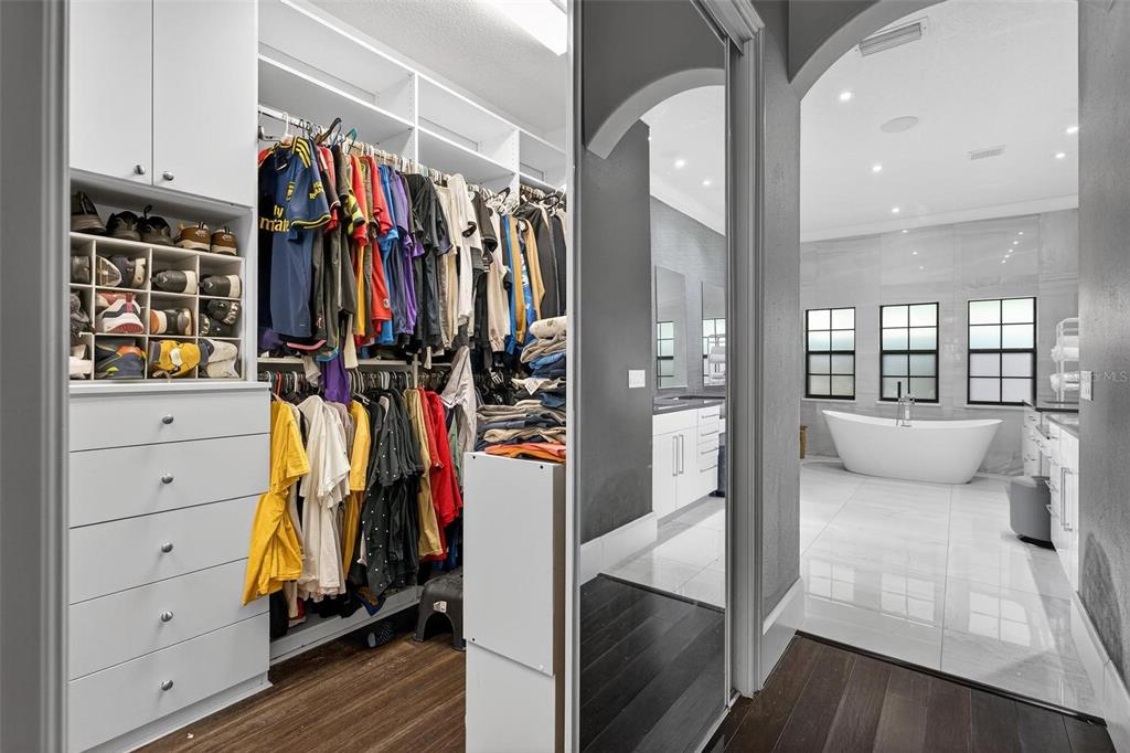 11015 Hawkshead Court Windermere, FL 34786 - Photo 22 of 90 a view of walk in closet with clothes and shoes