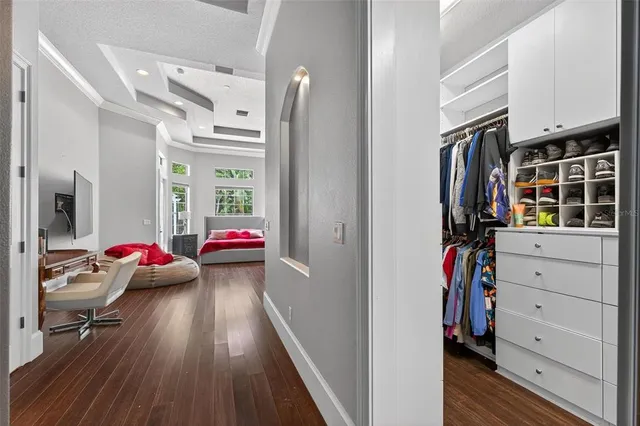 a dining room with furniture a chandelier and wooden floor