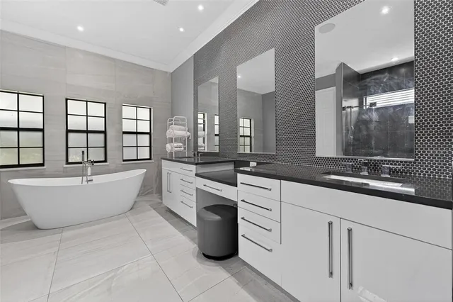 a large kitchen with stainless steel appliances kitchen island granite countertop a stove and a refrigerator