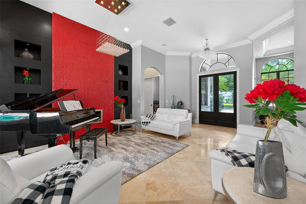11015 Hawkshead Court Windermere, FL 34786 - Photo 3 of 90 a living room with furniture a dining table and a potted plant