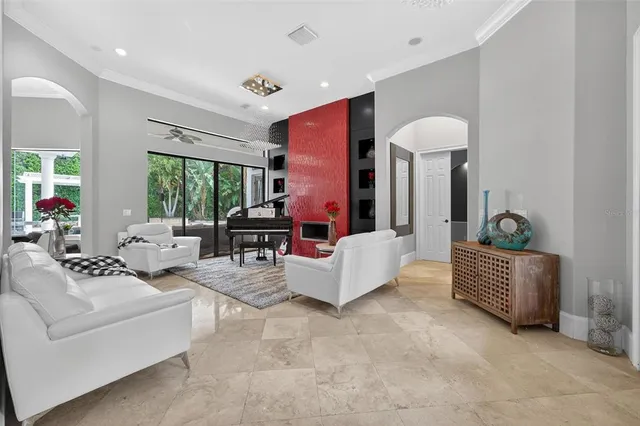 a living room with furniture and a floor to ceiling window