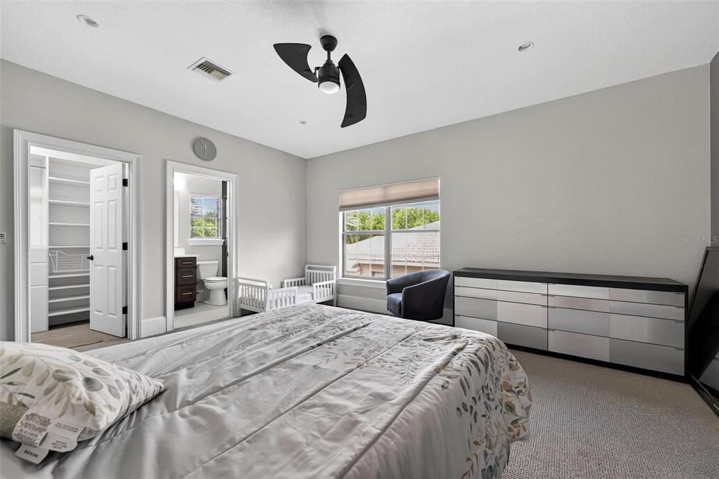 11015 Hawkshead Court Windermere, FL 34786 - Photo 41 of 90 a bedroom with a bed and a chandelier