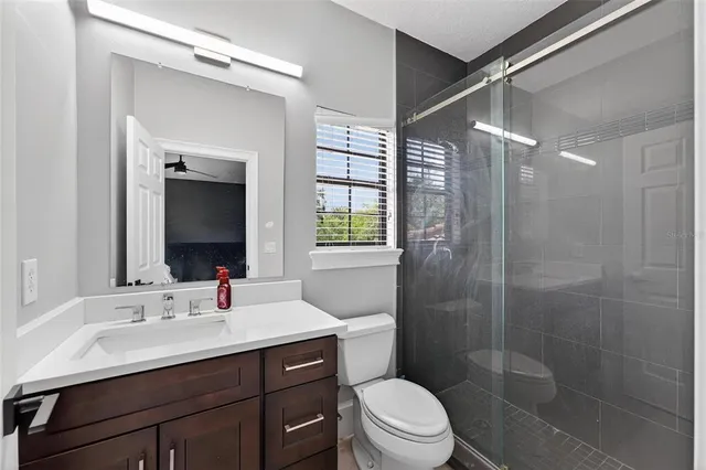 a view of swimming pool with a table and chairs under an umbrella