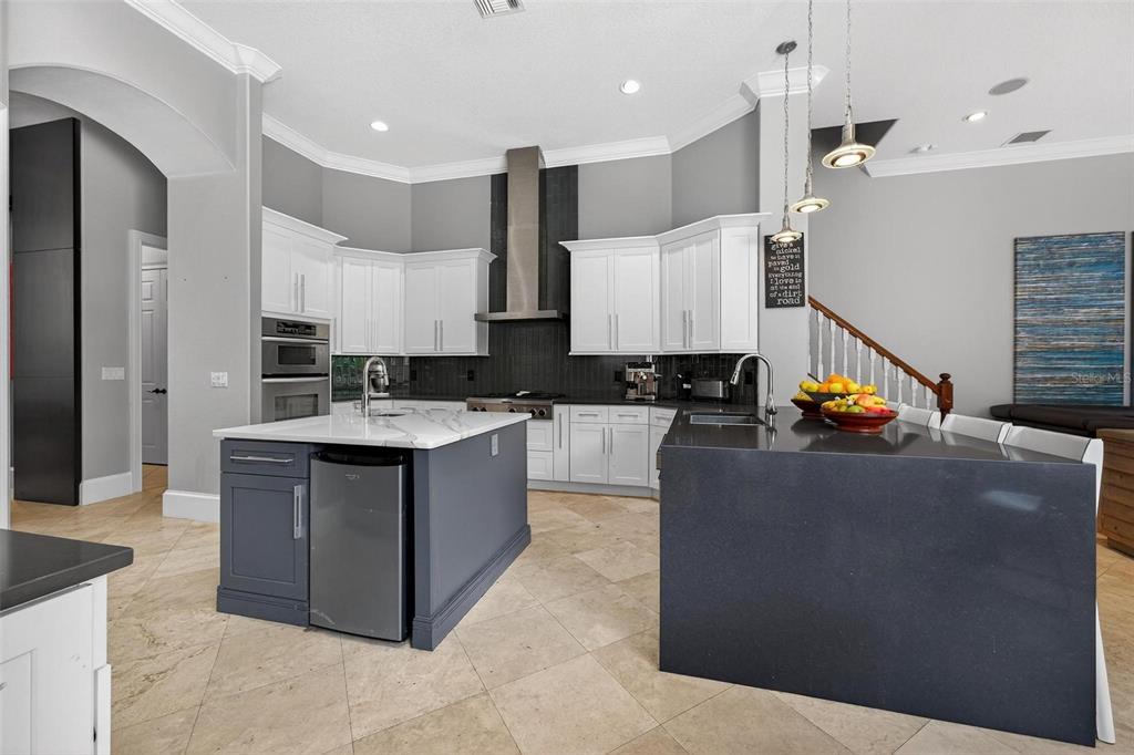 11015 Hawkshead Court Windermere, FL 34786 - Photo 47 of 90 a large kitchen with stainless steel appliances kitchen island granite countertop a stove and a refrigerator