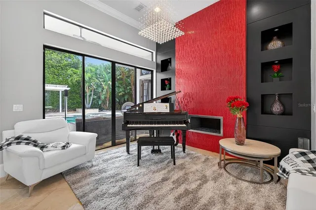 a living room with furniture a large window and dining table