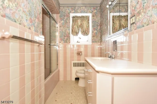 a bathroom with a sink a mirror and a shower