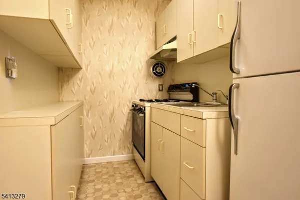 a kitchen with a refrigerator and cabinets