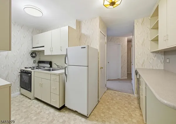 an empty room with wooden floor and cabinet