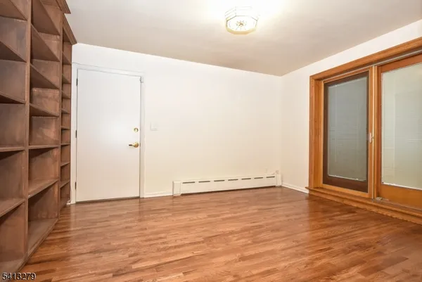 a view of an empty room with empty shelves