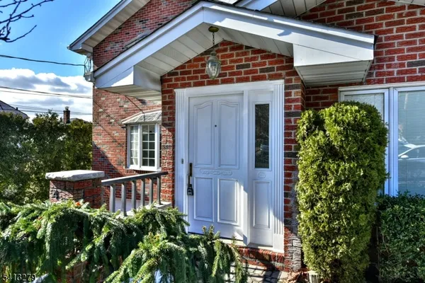 a front view of a house with plants