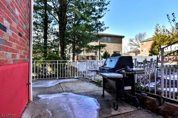 a view of a patio with a table and chairs under an umbrella