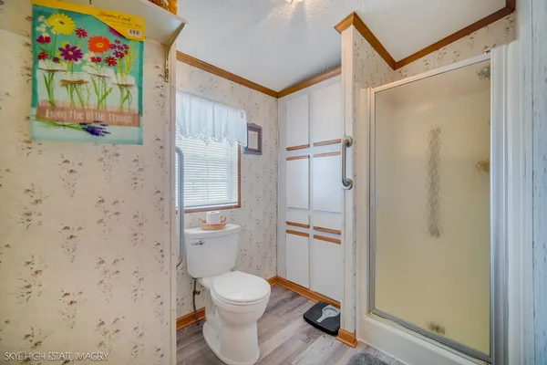 a bathroom with a toilet and a shower