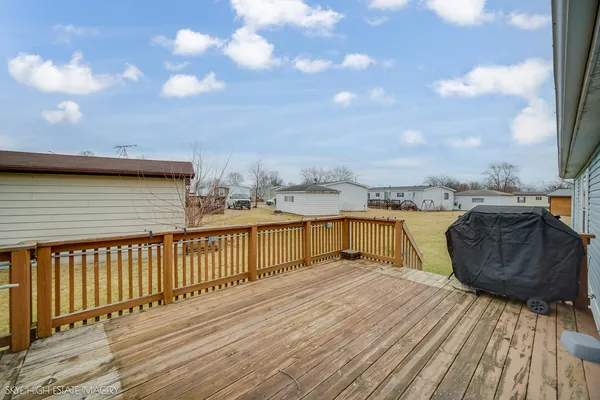 a view of a balcony with wooden floor and city view