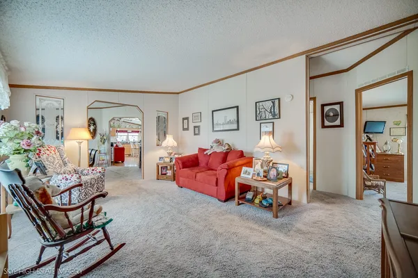 a bedroom with furniture and a large window
