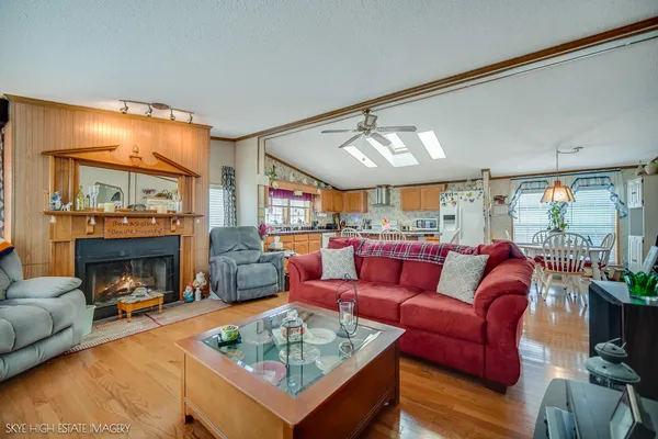 a living room with furniture a fireplace and a large window
