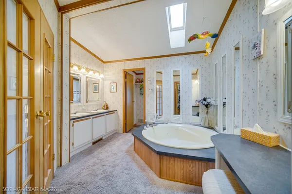 a bathroom with a tub toilet sink and mirror