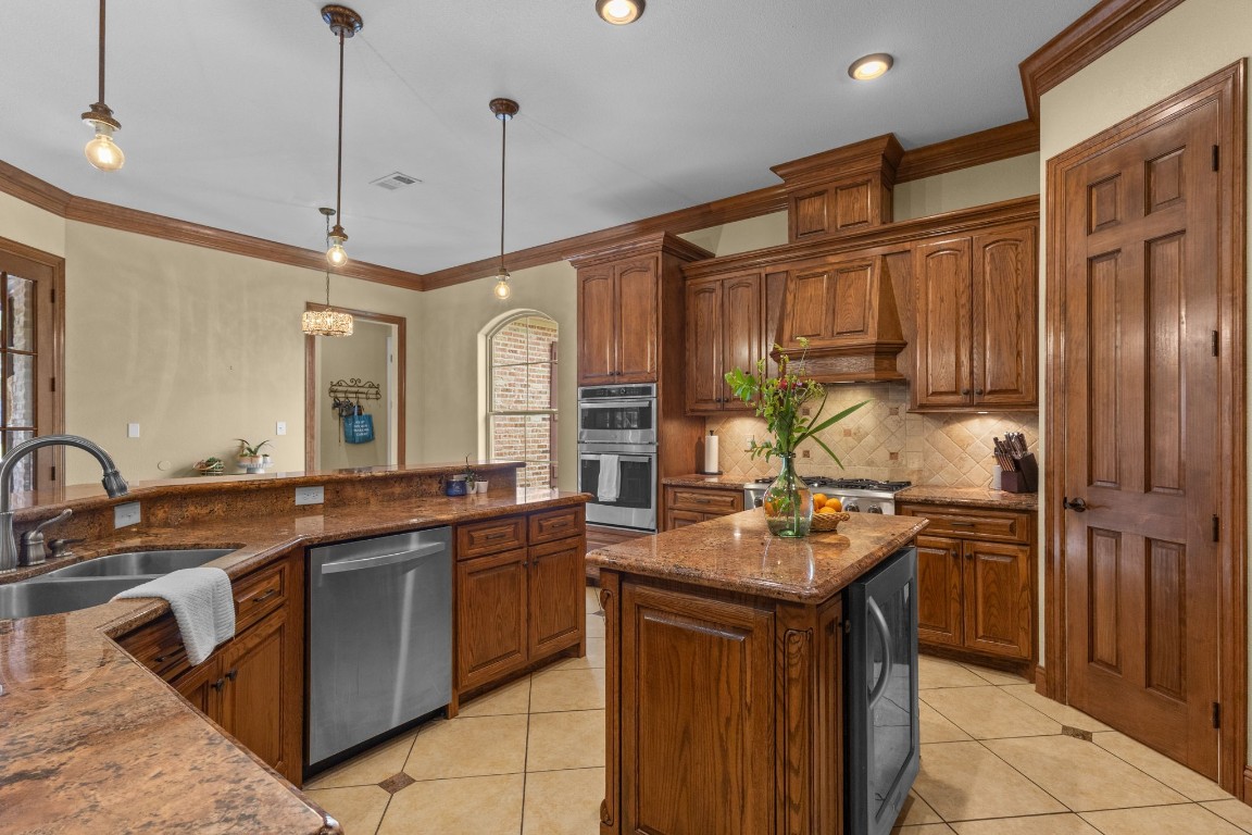 5535 Bearfoot Road Orange, TX 77632 - Photo 11 of 50 a kitchen with stainless steel appliances granite countertop a sink stove and refrigerator