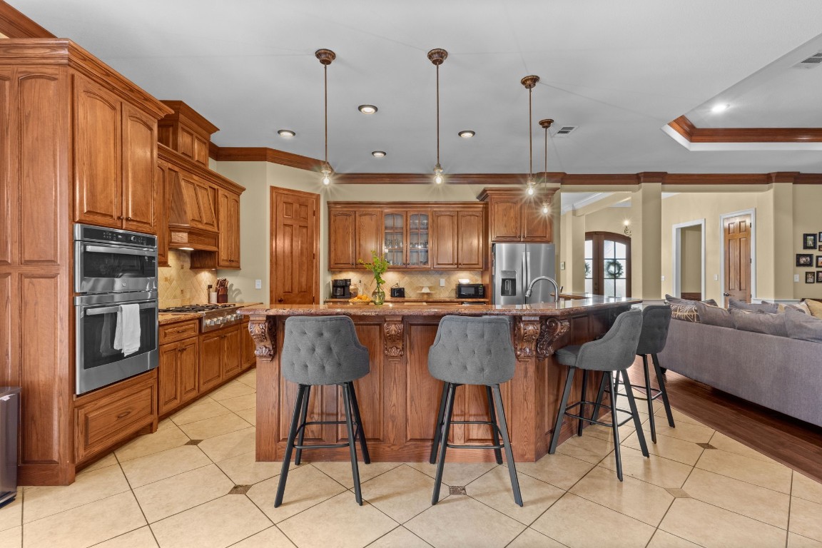 5535 Bearfoot Road Orange, TX 77632 - Photo 14 of 50 a dining hall with stainless steel appliances kitchen island granite countertop a table and chairs