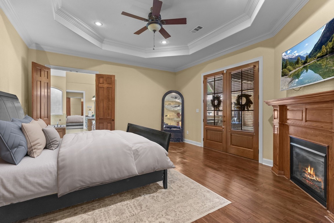 5535 Bearfoot Road Orange, TX 77632 - Photo 20 of 50 a bedroom with a bed wooden floor and a fireplace