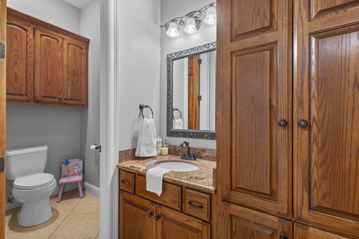 5535 Bearfoot Road Orange, TX 77632 - Photo 30 of 50 a bathroom with a toilet sink and mirror